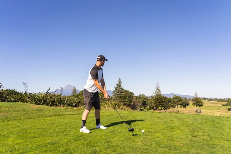 Golfer teeing off Ngamotu Golf Club - Source: Taranaki Story