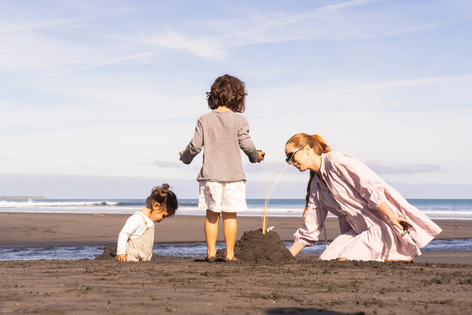 Opunake beach family building sandcastle - Source: Taranaki Story