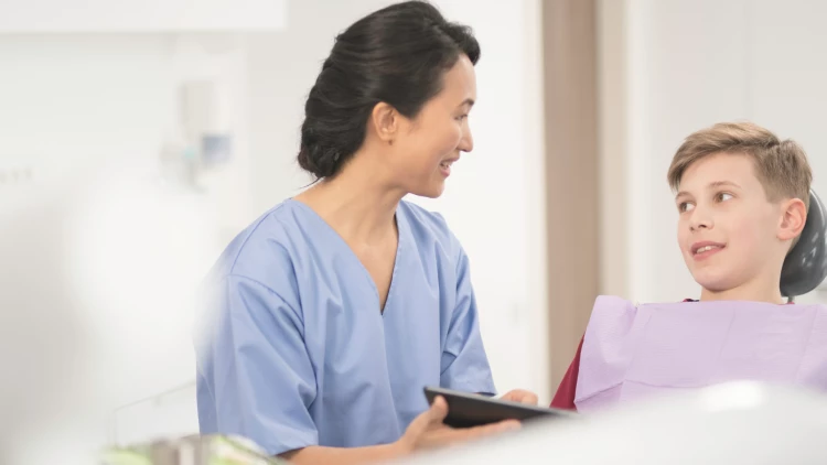 Oral Health Therapist educating patient (stock image)