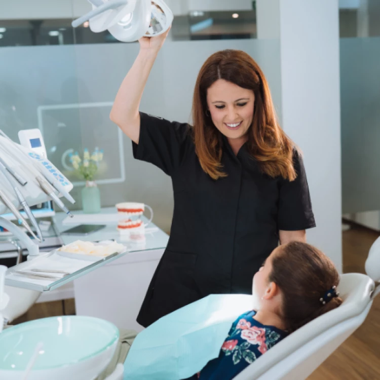 oral health therapist with young patient (stock image)