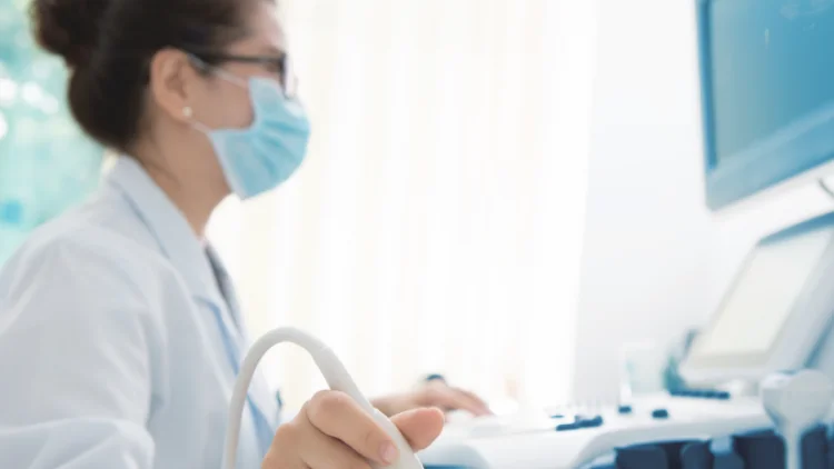 Sonographer with mask on (stock image)