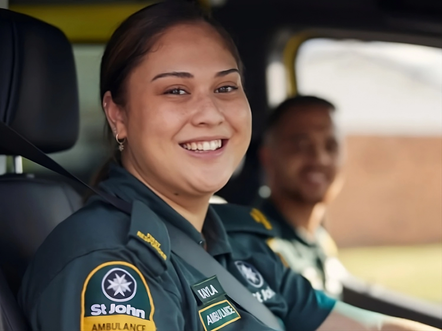 Two St. John paramedics in the front seat of a St. John ambulance