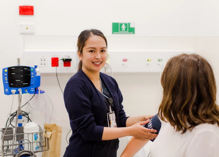 ESC nurse Melanie checking a patient's blood pressure in the patients' room